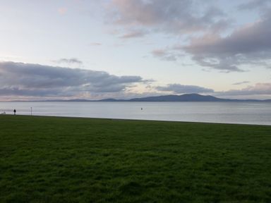 A person walking on grass near water at Mables in Wigton