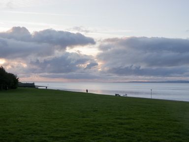A person walking by the water with clouds overhead at Mables in Wigton