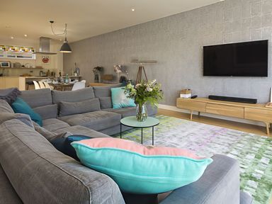 A living room with a sofa and coffee table at Villa 8, Estura, Salcombe
