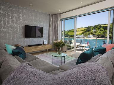 A living room with a sofa and television at Villa 8, Estura Salcombe