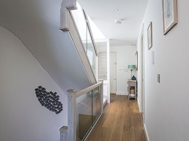 A hallway featuring a staircase and console table at Villa 8, Estura, Salcombe