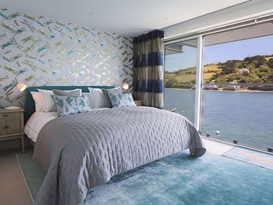 A bedroom with a bed and view of water at Villa 8, Estura in Salcombe