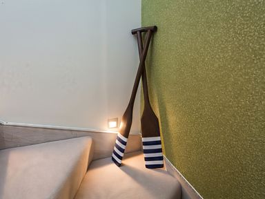 A staircase with wooden paddles mounted on the wall at Villa 8, Estura Salcombe