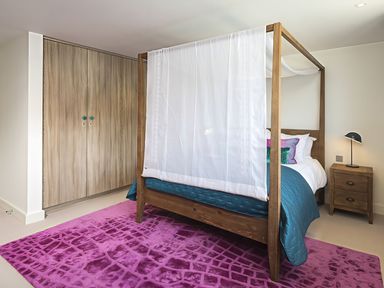 A bedroom with a canopy bed and wardrobe at Villa 8, Estura