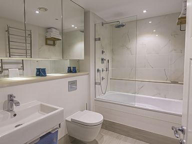 A bathroom with a sink, toilet, bath tub, and shower at Villa 8, Estura Salcombe