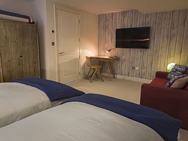 A bedroom with two beds and a desk at Villa 8, Estura Salcombe