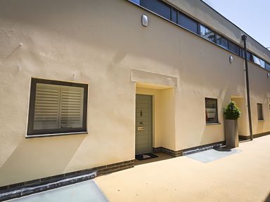 An exterior view showing a door and windows at Villa 8, Estura Salcombe