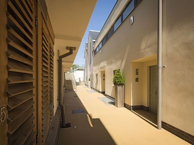A courtyard with a staircase and several doors at Villa 8, Estura in Salcombe