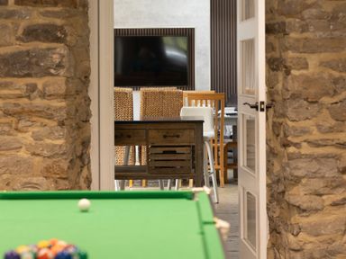 A game room with a pool table and a view of a dining area at 6 Front Street