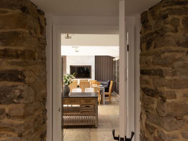 A dining room with a table and chairs viewed from a doorway at 6 Front Street