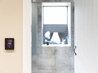 A thermostat and window view in a bathroom at 6 Front Street
