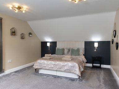 A bedroom with a bed and bedside table at 6 Front Street
