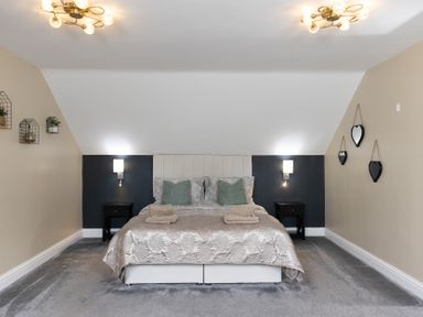 A bedroom with a bed and nightstands at 6 Front Street
