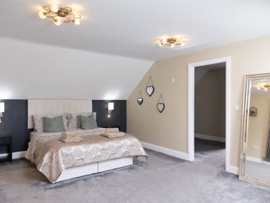 A bedroom with a bed and mirror at 6 Front Street 