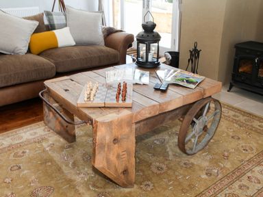 A living room with a coffee table and chess set at The Granary in Durham