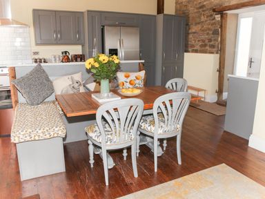 A dining area with a table and chairs at The Granary in Durham