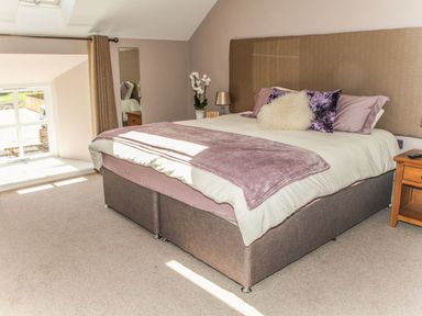 A bedroom with a bed and bedside table at The Granary in Durham