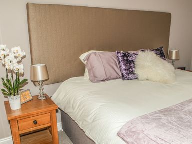 A bedroom with a bed and nightstand at The Granary in Durham