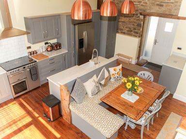 A kitchen with a dining area and modern appliances at The Granary in Durham