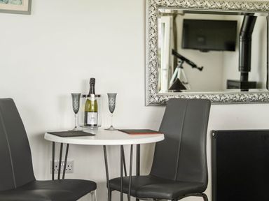 A dining area with champagne on the table at The lodge at Plumstone View Letterston