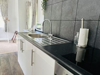 A kitchen with a sink and faucet at The Bark House in Tiverton