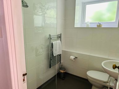 A bathroom with a towel rail and sink at The Bark House in Tiverton