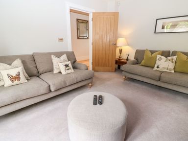 A living room with sofas and a coffee table at East View in Cheltenham