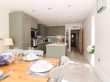 A kitchen with a dining table set at East View in Cheltenham