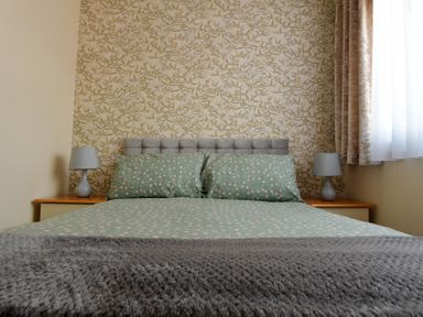 A bedroom with a bed and lamps at 228b Eighth Avenue Bridlington
