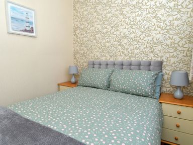 A bedroom with a bed and bedside table at 228b Eighth Avenue in Bridlington