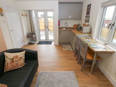 A kitchen with a table and chairs at Heidiaway Lodge in Gilfach Goch