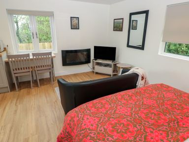 A living room with a bed and furniture at Heidiaway Lodge in Gilfach Goch