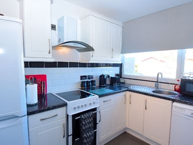 A kitchen with stove, sink, and refrigerator at 226 Third Avenue in Bridlington