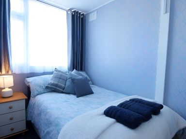A bedroom with a bed and bedside table at 226 Third Avenue in Bridlington