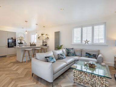 A living room with a sofa and coffee table at 6 Tegafan in Abergele