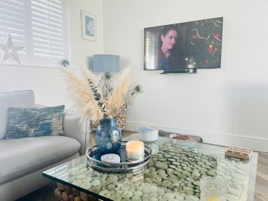 A living room with a coffee table and television at 6 Tegafan in Abergele
