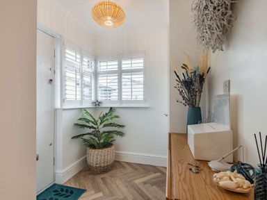 A hallway with a plant and decorative items at 6 Tegafan Abergele