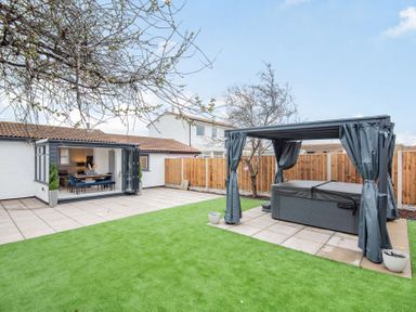 A garden with a hot tub and paved patio at 6 Tegafan Abergele
