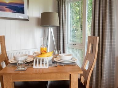 A dining table with tableware at Nethermill Lodges in Port Glasgow