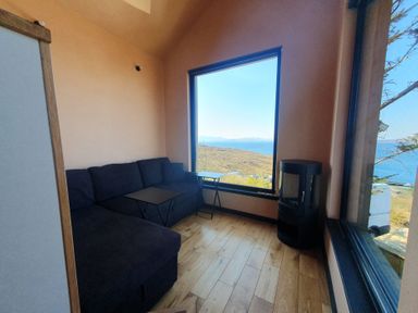 A snug with a sofa and a table at Cullinview in Isle of Skye