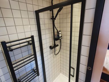 A shower with a towel rack and tiles at Cullinview Isle of Skye