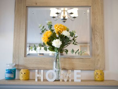 A display of flowers and decor on a shelf in Orchid 9 Christchurch