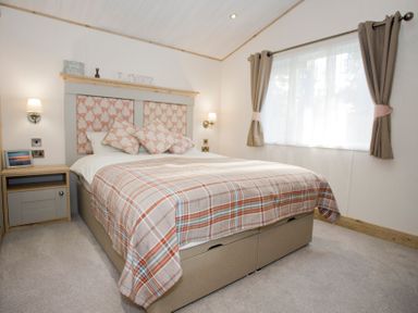 A bedroom with a bed and bedside table at Orchid 9 Christchurch