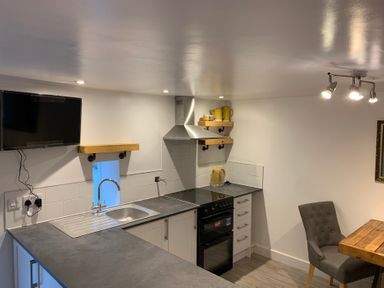 A kitchen with appliances and seating at The Haven in Penrith