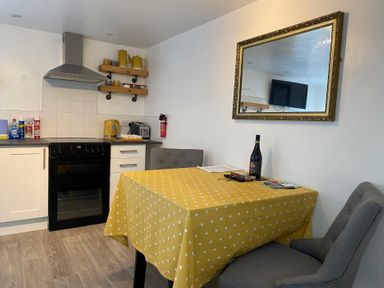 A kitchen with a table and chairs at The Haven in Penrith