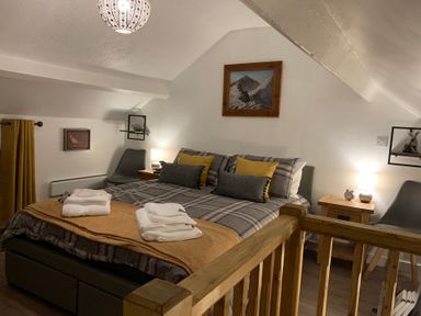 A bedroom with a bed and bedside tables at The Haven in Penrith