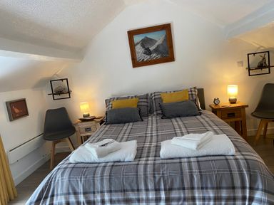 A bedroom with a bed and lamps at The Haven in Penrith