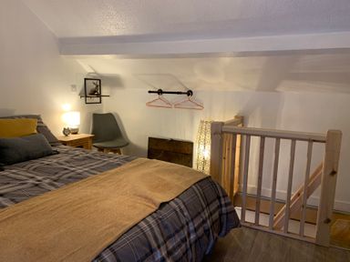 A bedroom with a bed and nightstand at The Haven in Penrith