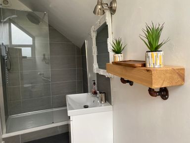 A bathroom with a shower and sink at The Haven in Penrith