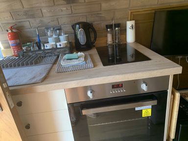 A kitchen with a kettle and an oven at Cosy Escape in Sheerness